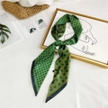 Green silk scarf with dark polka dots tied in a knot on a decorative background - Dark Green Polka Dot