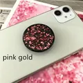 Detail of round expanding phone socket holder featuring sparkling rose gold foil inlay - Expanding Stand / Black Base Pink Foil