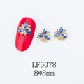 Macro detail of 8x8mm gold flower nail art charms with blue marquise crystals and rhinestones - 5078 Royal Blue