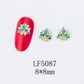 Macro detail of 3D flower nail art charms with green marquise gems and gold setting - 5087 Peacock Green