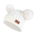 Detail of baby winter knit hat featuring double fur pom-poms and a leather brand patch - White Hat (White Pom Pom)