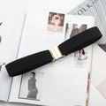 Detail of a black elastic waist belt with a gold metal buckle on a fashion magazine - Metal Square Buckle (Black)