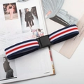 Detail of red white and blue elastic belt with black plastic buckle on magazine - Plastic Buckle (Blue/White/Red)