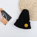 Close-up of the black ribbed knit beanie featuring a yellow embroidered smiley face patch - 50-56cm / Black