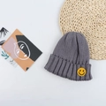 Detail of the grey ribbed knit hat featuring a bright yellow smiley face embroidery patch - 50-56cm / Gray