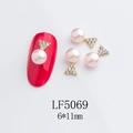 Close-up of pink pearl and gold star nail art charms on a manicured red nail detail - 5069 Light Pink Pearl Triangle Rhinestone Style