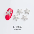 Macro shot of 12x12mm starfish nail charms with pearls and rhinestones on a red nail - Silver Rhinestone Pearl Starfish Style (5065)