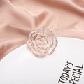 Rose gold flower brooch with crystal rhinestones and pearls on a silk fabric background - Rose Gold Hollow Flower