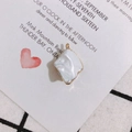 Close-up of irregular white marble pendant with gold plated edges for DIY jewelry making - White
