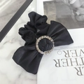 Elegant black scrunchie with sparkling rhinestone ring detail on marble background - Bow with Rhinestone / Black