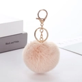 Portachiavi con pompon in ecopelliccia rosa e gancio dorato per borse e accessori - Albicocca