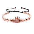 Close-up of rose gold beaded bracelet with crystal crown and adjustable black cord - Crown Bracelet / Rose Gold