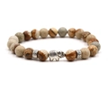 Detailed macro shot of beaded bracelet with a silver elephant charm and natural jasper stones - Jasper