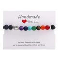 Handmade 7 chakras volcanic stone bracelet with a silver elephant charm on a gift card - Silver Elephant