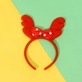 Plush Christmas reindeer antler headband with a red polka dot bow on vibrant background - Red Bow Antlers / Red