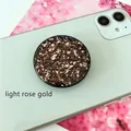 Close-up of light rose gold phone grip with glitter resin and metallic foil flakes - Expanding Stand / Black Base Light Rose Gold Foil