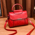 Vintage red leather handbag with metal round handle and adjustable shoulder strap - Burgundy