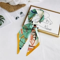 Green silk skinny scarf with horse carriage pattern tied in a bow on a straw bag - Yellow Belt Horse