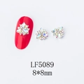 Detailed view of 8x8mm gold flower nail art charm with AB rhinestones on red nail - 5089 AB Color