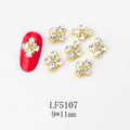 Macro detail of 9x11mm gold floral nail charms with sparkling crystals on red nail art - 5107 Iridescent White + White