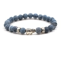 Ethnic blue turquoise beaded bracelet with silver elephant pendant on white background - Blue Crack Stone