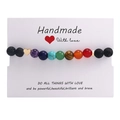 Handmade chakra beaded bracelet with black lava stone and golden heart charm on card - Gold Heart