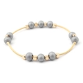 Detailed close-up of golden spring wire bracelet with matte grey beads on white background - Gold Spiral Wire with Gray Frosted Beads