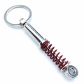 Silver car shock absorber keychain with a red coil spring and a metal ring - Red Shock Absorber
