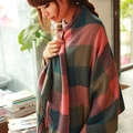 Detail of pink and green plaid scarf with soft fringe trim in a cozy bookstore setting - Dark Pink and Brown Plaid