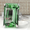 Emerald cut green zircon engagement ring in platinum plated copper with side stones - Green
