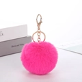 Detail of pink faux rabbit fur keychain with polished gold metal clasp and chain - Rose Red