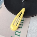 Minimalist bright yellow BB clip hair pin with glossy finish on a decorative background - Yellow