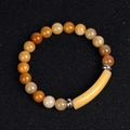 Detailed macro shot of yellow tiger eye stone beads and a curved bridge bar on the bracelet - Old Yellow Jade