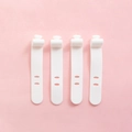 Set of four white flexible silicone cable organizers for earphone wire management - Set of 4 / White