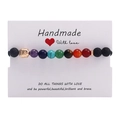 Handmade chakra bracelet with volcanic lava stone and golden Buddha head on card - Gold Buddha Head