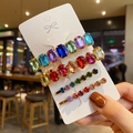 Close-up of four gold hairpins with colorful rhinestones on a white display card - Style D