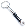 Car shock absorber keychain with chrome metal finish and black spring on white background - Black Shock Absorber