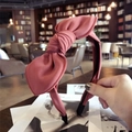 Dusty rose fabric headband featuring a large bow knot and textured fabric finish - Rose Red