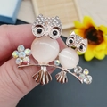 Gold-plated owl brooch with opal stones and sparkling rhinestones held in hand - No. 14-Gold Cat Eye Owl