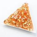 Faceted amber glass ring beads for nail art and jewelry making in white tray - Gold Rose Red