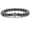 Close-up of hematite bead bracelet with gold skull charm and black cubic zirconia stones - Gold