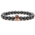 Detailed macro view of hematite beads and rose gold skull with red zircon eyes - Rose Gold