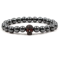 Close-up of hematite bead bracelet with red-eyed zircon skull head in gothic style - Gun Black