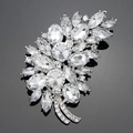 Elegant silver leaf brooch with clear marquise cut crystal stones on reflective surface - Silver White