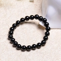 Polished 10mm black onyx bead bracelet on a minimalist textured zen background - 8MM Natural Black Agate