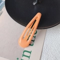 Orange teardrop hair clip with a smooth matte finish on a minimalist background - Orange