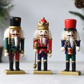 Three 15cm wooden nutcracker soldiers in red, green, and blue Christmas uniform variants - M15301