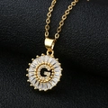 Macro detail of gold letter G pendant with baguette-cut zircon stones on a black leather surface - Letter G (Without Chain) Gold