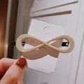 Elegant cream white infinity hair clip on display card with black metal spring clip - Large Infinity Shape / Off-white