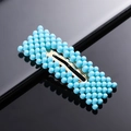 Detailed view of rectangle gold hair clip with dense blue spherical bead embellishments - Blue Rectangle